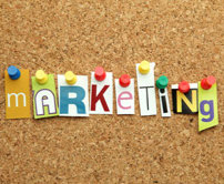 push pins holding up individual pieces of paper that spell out marketing