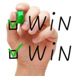 Picture of a hand making check marks in boxes that say "win" next to them